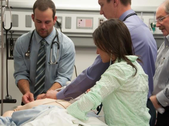 Clinical Research System Support -  4 Doctors working on patient